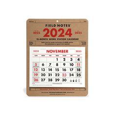 a calendar hanging on a wall with the words field notes 2024 in red and white