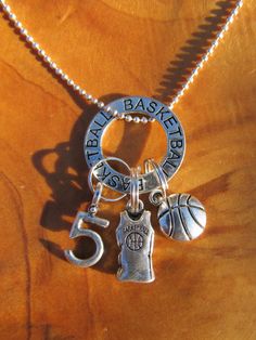 a basketball keychain with charms attached to it