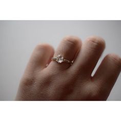 a woman's hand with a diamond ring on it