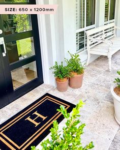 two potted plants are sitting on the front porch next to a door mat that says, size 650 x 120mm