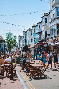 many people are sitting at tables on the street