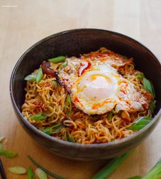 a bowl filled with noodles and an egg on top