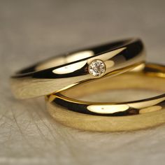 two yellow gold wedding rings with a diamond