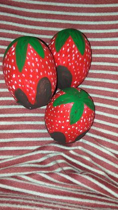 three strawberries painted on top of each other