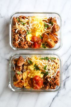 two plastic containers filled with food on top of a marble counter