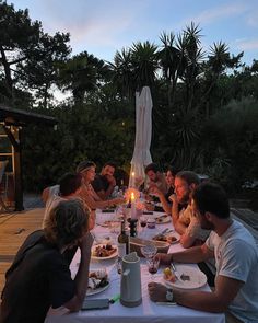 a group of people sitting around a dinner table