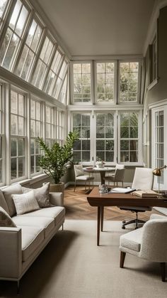 a living room filled with furniture and lots of windows