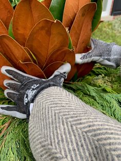 gloves and flowers are sitting on the ground