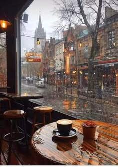 an outdoor cafe with tables and chairs on a rainy day, looking out the window