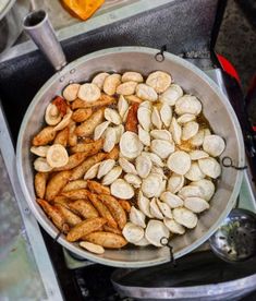 a pan filled with nuts sitting on top of a stove