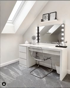 a white desk topped with a mirror next to a chair and a window in a room