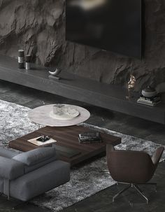 a living room with a couch, chair and coffee table in front of a flat screen tv