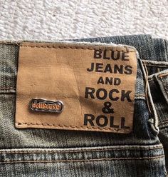 blue jeans and rock and roll sticker on the back pocket of someone's jean pants