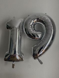 the number nine balloon is hanging on the wall