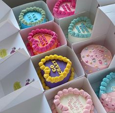 there are many decorated cakes in the boxes