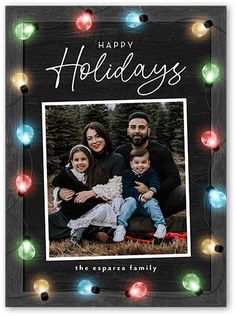 a holiday card with the words happy holidays and an image of a family surrounded by christmas lights