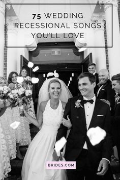 a bride and groom walking down the aisle with confetti flying in the air