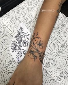 a woman's foot with a flower tattoo on it