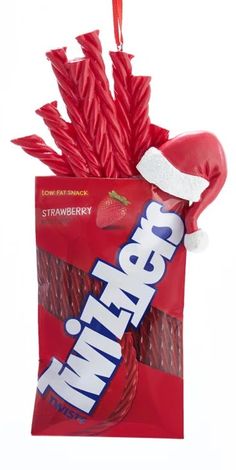 a red bag filled with strawberries on top of a white background and a candy bar in the middle