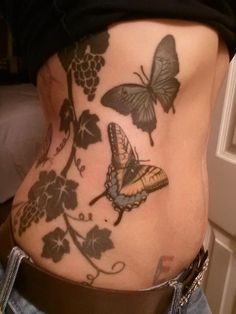 a woman's stomach with butterflies on it