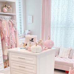 a room filled with lots of white furniture and pink accessories on top of it's drawers