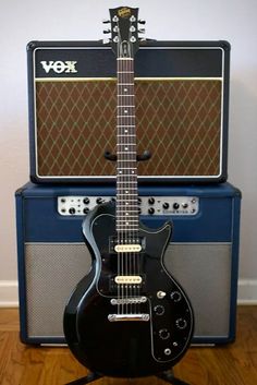 an electric guitar sitting on top of a wooden floor