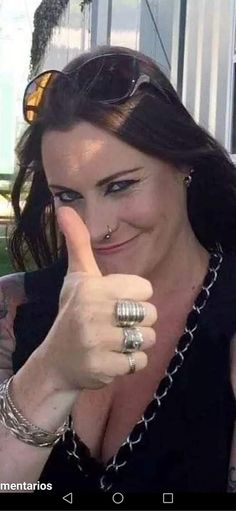 a woman giving the peace sign with her fingers