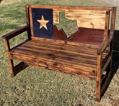 a wooden bench with the state of texas painted on it's back and sides