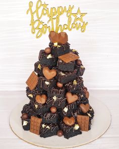 a cake made to look like a christmas tree with lots of chocolates on top