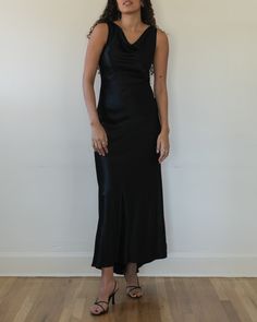 "Black cowl neck bias cut evening dress c. 1990s. Double-layered viscose blend satin. Sleeveless construction with cowl neckline. Fitted throughout bodice with slightly more relaxed fit from hips down. V cut back with subtle train. Invisible zipper at back center. tag size: 4 modern size estimate: small composition: 54% viscose 46% acetate (100% acetate lining) label: ABS Evening by Allen Schwartz made in USA condition: excellent MEASUREMENTS bust - 32\" waist - 27\" hips - 35\" length (front) - 59\" length (back) - 61\" shown unpinned on a 5'9\", size small model please review our shop policies prior to purchase" Luxury Slip Dress With Ruched Bodice And Sweetheart Neckline, Luxury Satin Dress For Dinner With Bias Cut, Luxury V-neck Slip Dress With Bias Cut, Luxury Elegant Satin Dress With Bias Cut, Luxury Chic Slip Dress With Cowl Neck, Vintage Black Silky Maxi Dress, Luxury Asymmetrical Bias Cut Satin Dress, Luxury Slip Dress With Cowl Back For Gala, Elegant Cheap Scoop Neck Dress