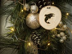 a christmas wreath with ornaments hanging from it's sides and an ornament in the center