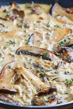 a skillet filled with chicken and mushrooms covered in gravy