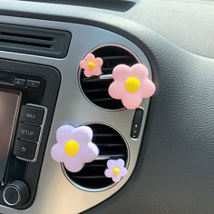 car dashboard air vent with flower decorations on it