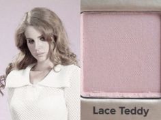 a woman standing next to a pink wall with the words lace teddy written on it