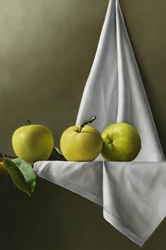 an oil painting of apples on a cloth hanging from a clothesline, with one green apple in the foreground