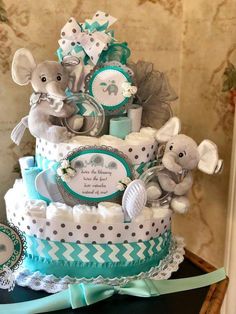 a baby shower cake with elephants and diapers