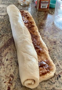 a long piece of bread sitting on top of a counter