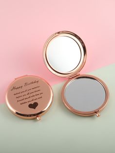 two compact mirrors sitting next to each other on a pink and green surface with the words happy birthday written in it