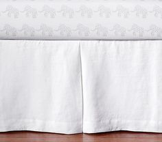 the bed skirt is white with elephants on it