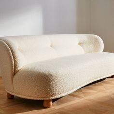 Generously cushioned to hug you as you sit, the Leonne long settee by goop features soft curves for a grand statement on a small scale. The sweeping curved back, tufted buttons and teardrop-shaped American white oak legs certified sustainable by the Forest Stewardship Council r FSC come together for a piece that is elevated and timeless. Designed for small spaces, the sophisticated settee is also perfect for creating intimate seating in larger rooms. CB2 exclusive.  -Designed by goop -FSCr-certi Fun Sofa, Navy Velvet Chair, White Wood Furniture, Fabric Sectional Sofas, Walnut Furniture, Apartment Sofa, Leather Sectional Sofa, Linen Sofa, Curved Sofa