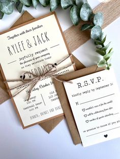 the wedding stationery is tied up with twine and paper, along with some greenery