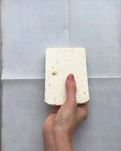 a hand holding up a piece of food