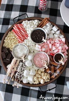 a platter filled with marshmallows, chocolate and candy