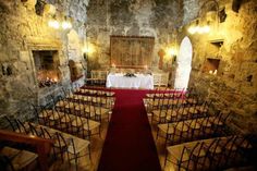 an empty church with rows of chairs and a table set up for a wedding ceremony