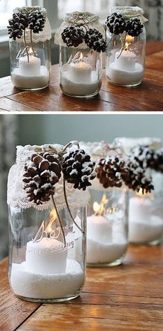 pine cones and candles are in mason jars with snow on the top, and one is lit