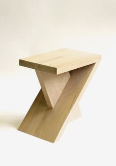 a small wooden table sitting on top of a white floor