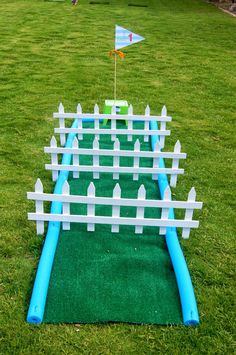 an inflatable golf course on the grass with a flag sticking out of it