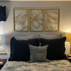 a bed with two framed pictures above it