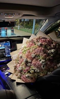 a bunch of flowers sitting on top of a car dashboard