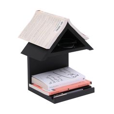 a black book holder with books and glasses on it